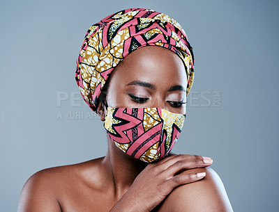 Buy stock photo Studio shot of a beautiful young woman wearing a mask against a grey background