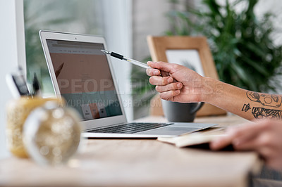 Buy stock photo Shot of an unrecognisable man using a laptop while working from home