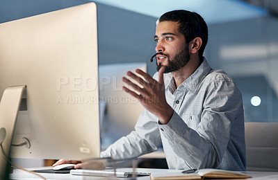 Buy stock photo Call center, man and talking at computer for customer service, telemarketing sales and CRM consulting at night. Male agent, desktop pc and communication for advice, questions and technical support