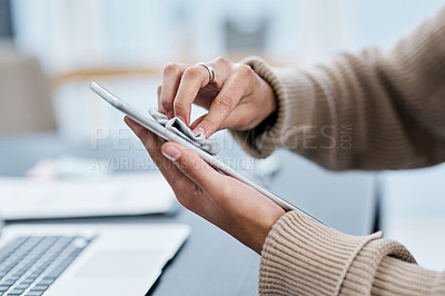 Buy stock photo Shot of an unrecognisable man disinfecting his digital tablet while working from home