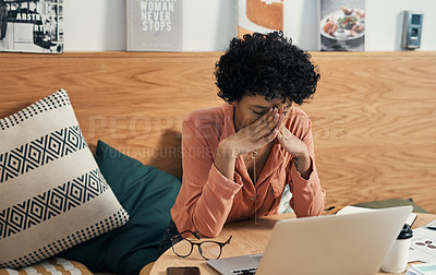 Buy stock photo Shot of a woman looking stressed while working from a cafe