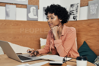 Buy stock photo Shot of a businesswoman using her laptop while working at a cafe