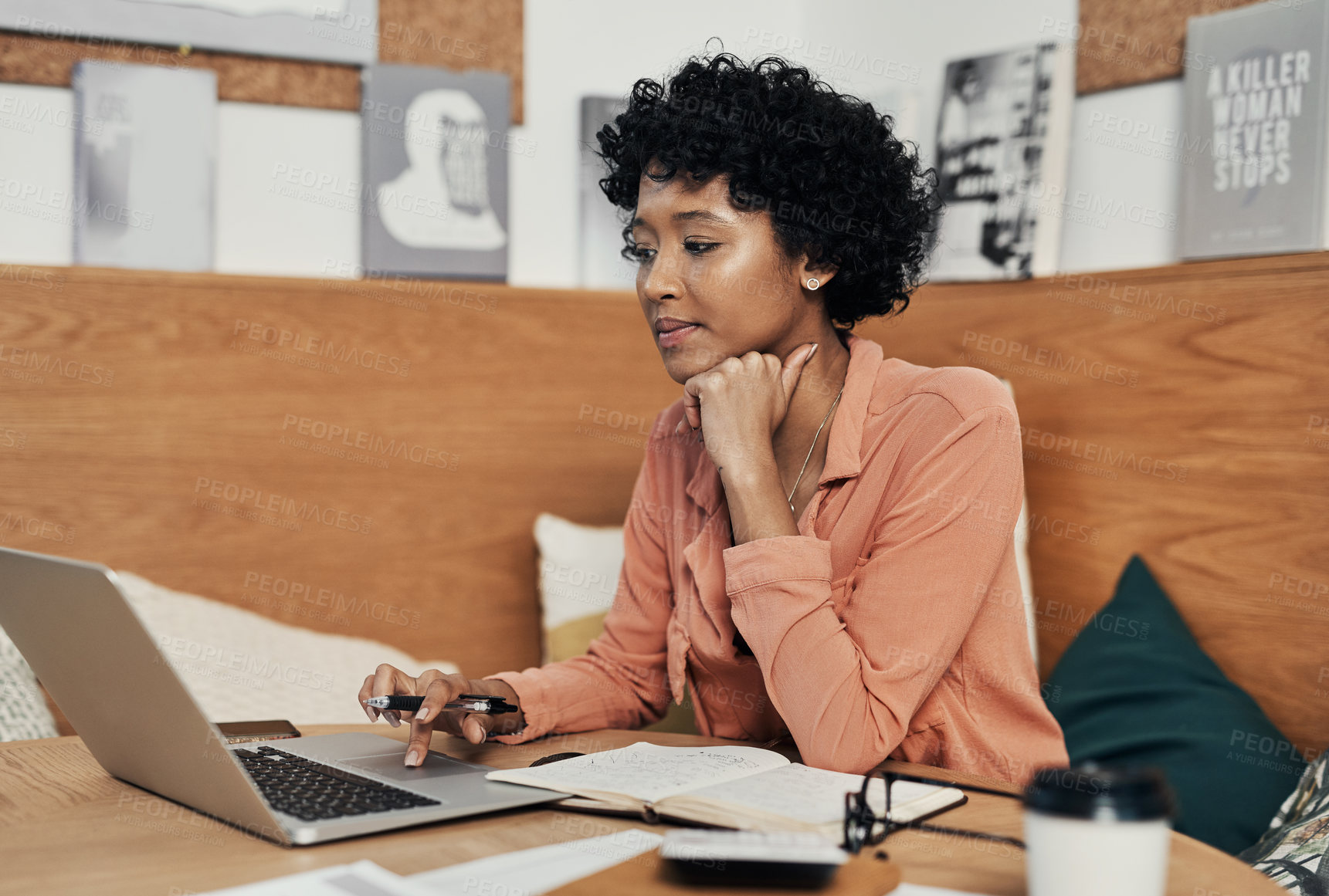 Buy stock photo Shot of a businesswoman using her laptop while working at a cafe