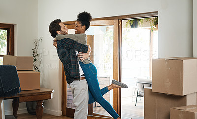 Buy stock photo Happy interracial couple hug in new home for property relocation, renovation or investment together. Excited man embrace woman in real estate, house and boxes for moving, mortgage loan or celebration