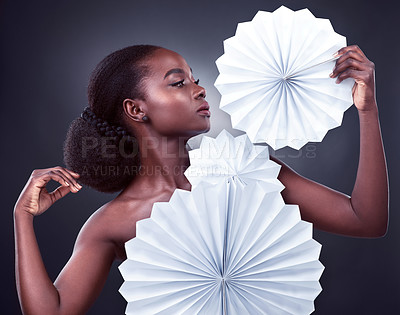 Buy stock photo Beauty, fashion and black woman with origami, stylish and confident against a dark studio background. Female person, model or girl with trendy outfit, paper and glamour with elegant clothes and style
