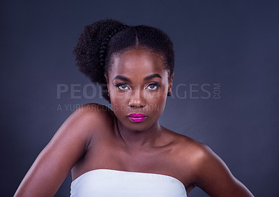 Buy stock photo Studio portrait of a beautiful young woman posing against a black background