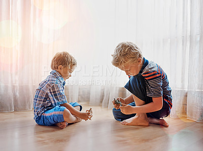 Buy stock photo Shot of two little boys playing together at home