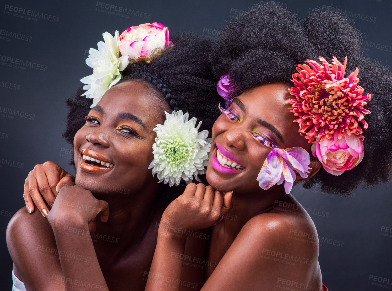 Buy stock photo Smile, fashion and black women with flowers in studio for springtime, rejuvenate and natural beauty on gray background. Friends, happy and colorful with makeup for art, design and elegance for summer