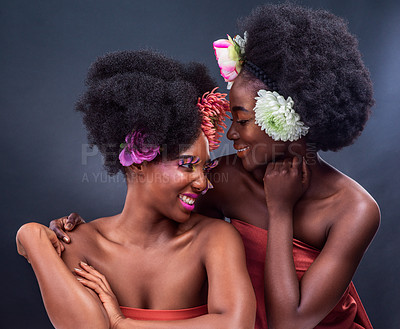 Buy stock photo African, beauty and creative friends with flowers in makeup and art in dark background, studio and mockup. Floral, cosmetics and black woman with support, care and natural skincare with happiness