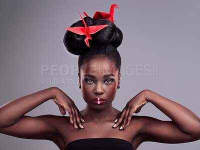 Buy stock photo Black woman, portrait and origami bird in studio isolated on gray background with makeup for aesthetic. Cosmetics, tradition and beauty, skincare and shine with pride, honour and cultural diversity