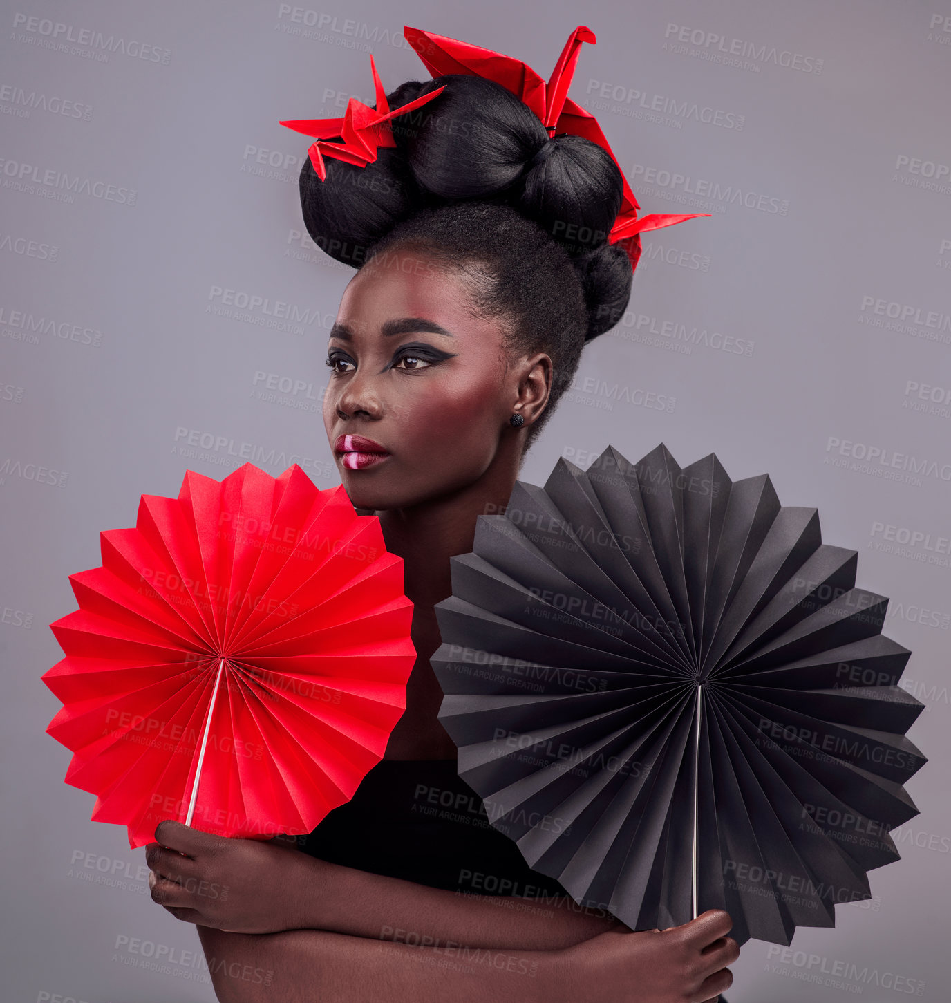 Buy stock photo Beauty, cosmetics and origami with black woman in studio for creative, art and culture. Traditional, makeup and paper design with female model and fans on grey background for asian, retro or color