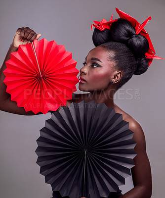 Buy stock photo Art, makeup and creative with black woman in studio for origami, beauty and culture. Traditional, cosmetics and paper design with female model and fans on grey background for fashion, retro or color