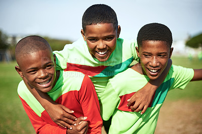 Buy stock photo Shot of a group of young boys playing soccer on a sports field