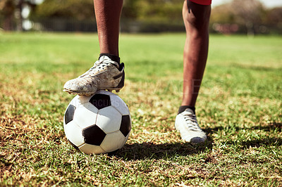 Buy stock photo Closeup shot of a young boy playing soccer on a sports field