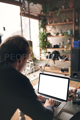 Buy stock photo Cropped shot of an unrecognisable man using a laptop at home