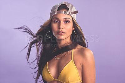 Buy stock photo Woman, fashion and studio with confident portrait, beauty and makeup with female model in bikini with cap. Purple background, summer style and accessories with funky eye shadow, wind and serious