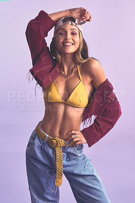 Buy stock photo Studio shot of a beautiful young woman posing against a purple background
