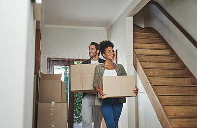 Buy stock photo Excited, happy and young couple moving into a new home together while carrying and packing household boxes. Smiling, positive and cheerful husband and wife in a lovely modern real estate property