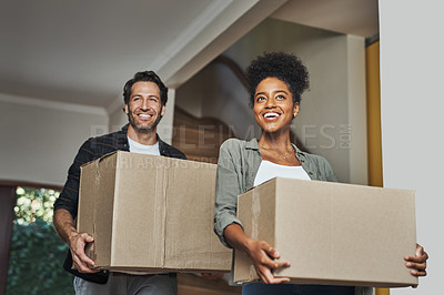 Buy stock photo New house, moving and happy couple carrying boxes while feeling proud and excited about buying a house with a mortgage loan. Interracial husband and wife first time buyers unpacking in dream home 
