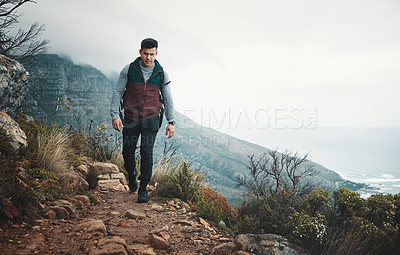 Buy stock photo Hiking, trail and travel with man on mountain for explore, walking and adventure. Challenge, wellness and holiday with person and trekking in nature path for backpacking, fitness and vacation
