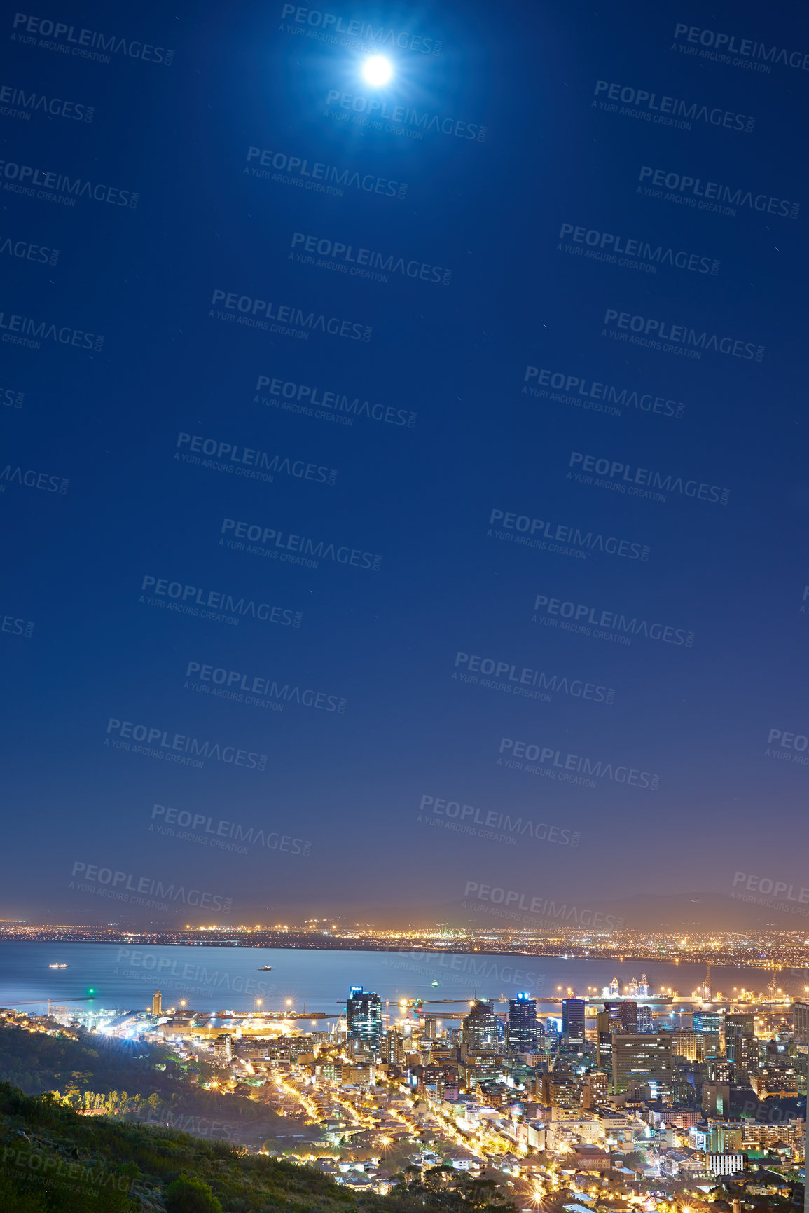 Buy stock photo Urban city lights with a full moon in the midnight sky with copy space. Skyline with colorful lighting with the wide open ocean on the horizon. City buildings at night in Signal Hill, South Africa