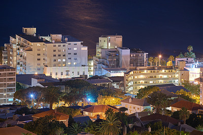 Buy stock photo Night cityscape view of city buildings with electricity lights, infrastructure and sea or ocean background in abroad travel destination. Cape Town, South Africa downtown centre and urban architecture