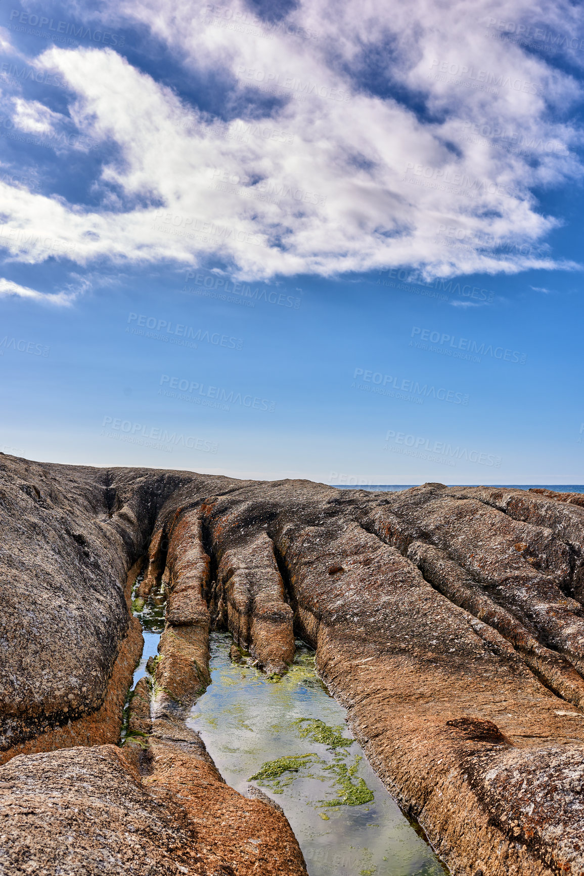 Buy stock photo Background, blue sky and water in outdoor environment for earth day, space or summer clouds. Nature, rocky terrain and wallpaper with coastal location in morning for landscape, ecology or scenery