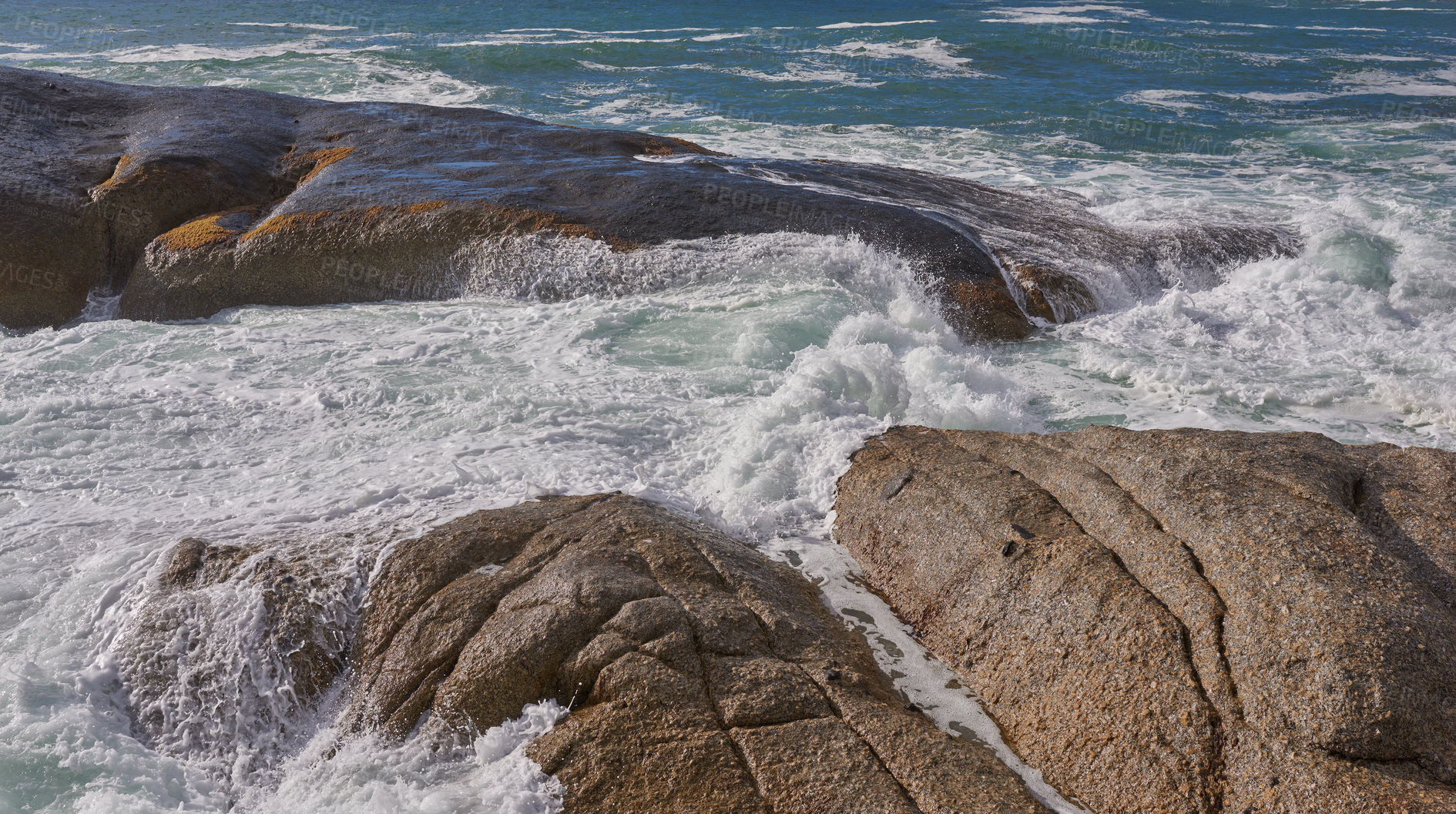 Buy stock photo Scenic ocean view of beach with rocks or boulders and sea water washing onto shore during peaceful summer vacation in tropical resort and island overseas. Rough texture and detail of rocky coastline