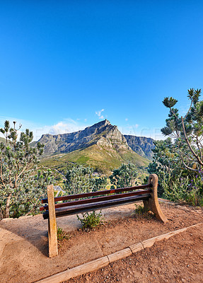 Buy stock photo Relaxing botanical garden park bench to enjoy zen landscape view of scenic mountains and nature reserve. Table Mountain National Park in Cape Town, South Africa with calm blue sky and local seating 