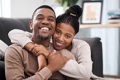 Buy stock photo Love, hug and portrait of a happy couple on sofa in the living room of their modern home. Happiness, smile and black woman relax with husband, care and marriage on couch at the house lounge together