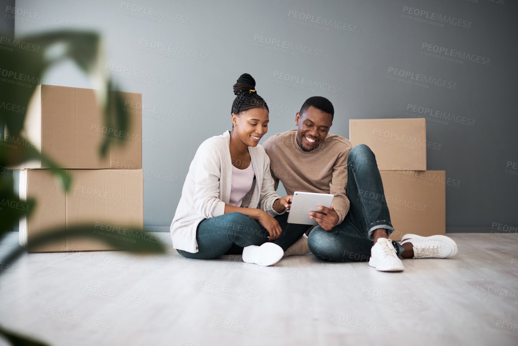 Buy stock photo Real estate, property and black couple with boxes and tablet for furniture shopping or search renovating ideas. Happy owners, relocation and tenants on digital touchscreen on moving day in new home.