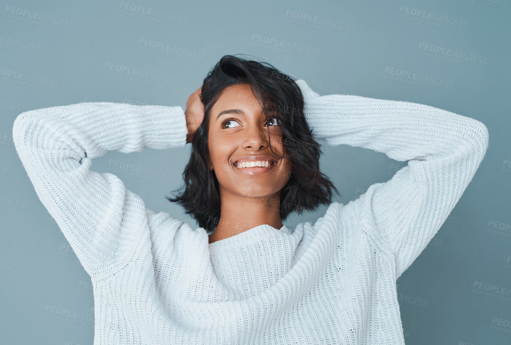 Buy stock photo Cropped shot of a beautiful young woman posing against a teal background