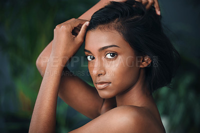 Buy stock photo Shot of a beautiful young woman posing against a dark background