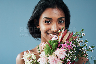 Buy stock photo Cropped shot of a beautiful young woman posing with a bouquet of flowers