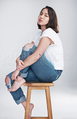 Buy stock photo Studio, asian woman and portrait on stool for fashion, comfortable and stylish with casual clothes. Female person, model and serious on chair for trendy outfit, cool and hipster by white background