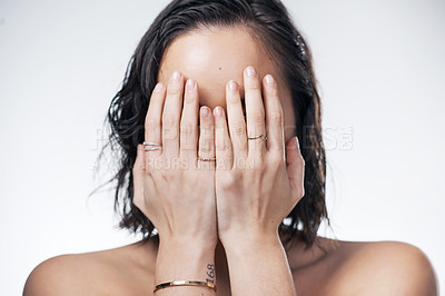 Buy stock photo Cropped shot of a beautiful young woman covering her face