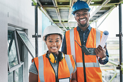 Buy stock photo Happy and proud African American engineers at a construction site planning a building together. Portrait of young contractors standing at an apartment to be renovated for a project together