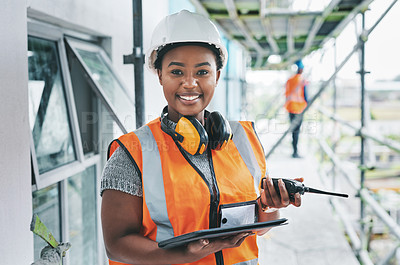 Buy stock photo Portrait of proud black construction worker leading with power while managing site logistics on tablet. Happy female engineer supervising a building project and inspection of  architectural details 