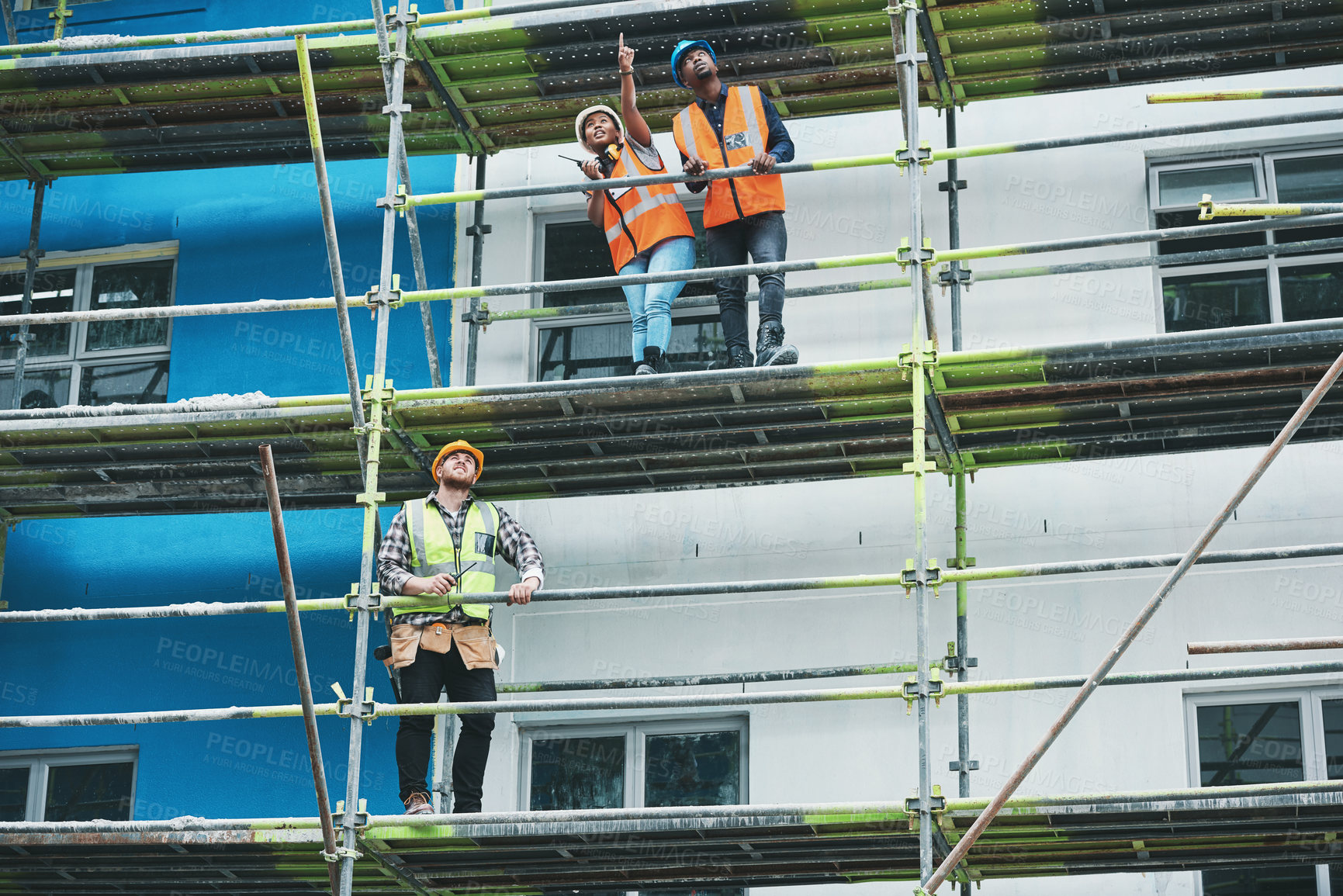 Buy stock photo Team, man and woman on construction site with planning, collaboration and urban architecture. Ideas, people and contractor on scaffolding for civil engineering, building and property development.