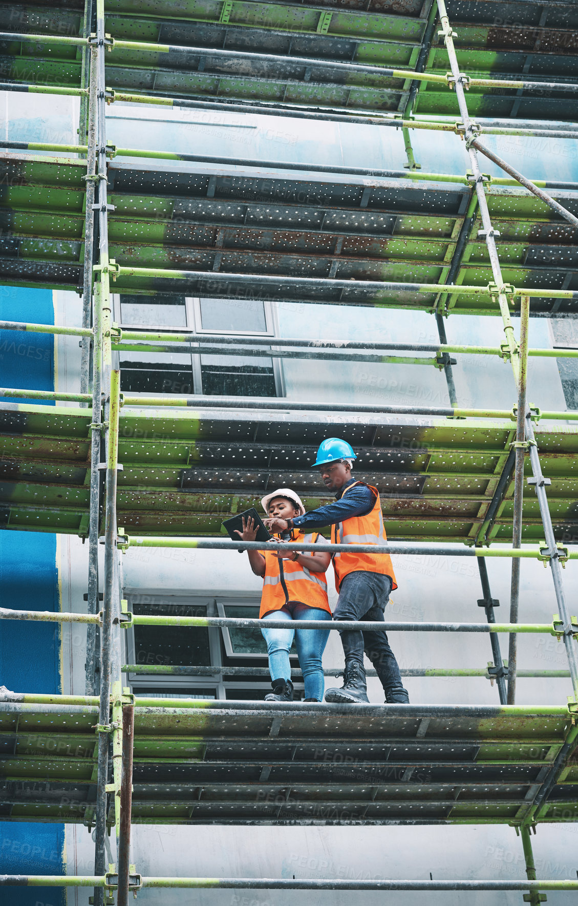 Buy stock photo Tablet, man and woman on construction site with planning, collaboration and urban architecture. Digital app, discussion and contractor team on scaffolding for civil engineering, building and ideas