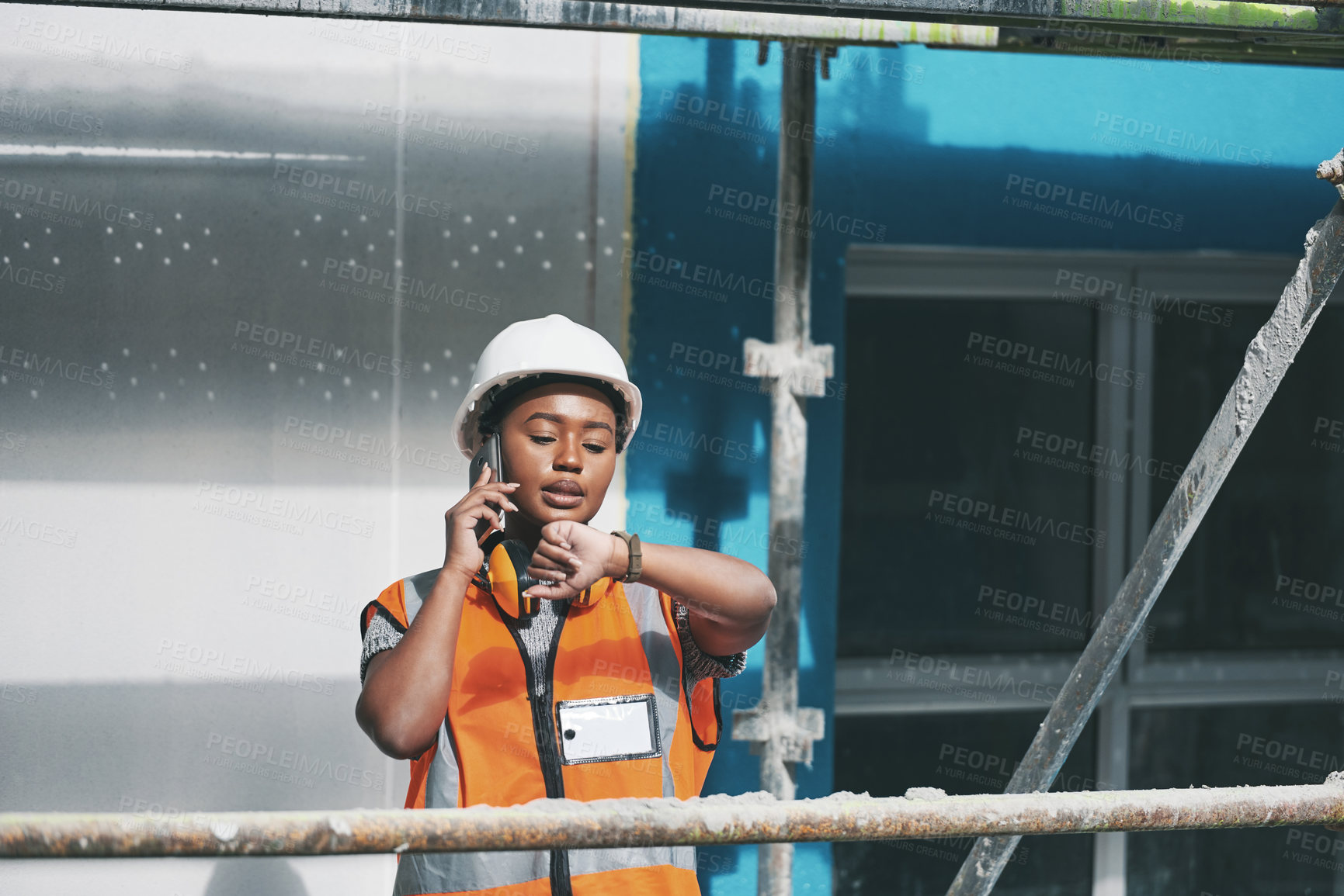 Buy stock photo Planning, construction and black woman on site with phone call, time management and architecture. Smartphone, discussion and contractor at scaffolding checking watch for civil engineering schedule