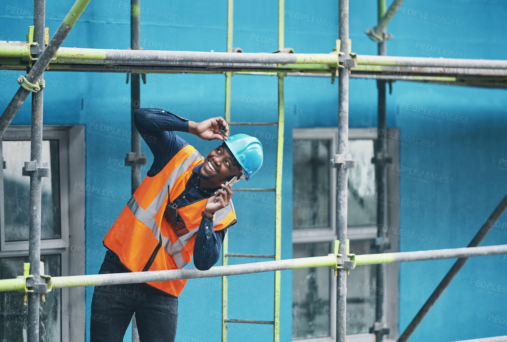 Buy stock photo Phone call, construction site and black man with scaffolding, hard hat and architecture for city development. African person, inspector and engineering with safety, cellphone or contact with planning