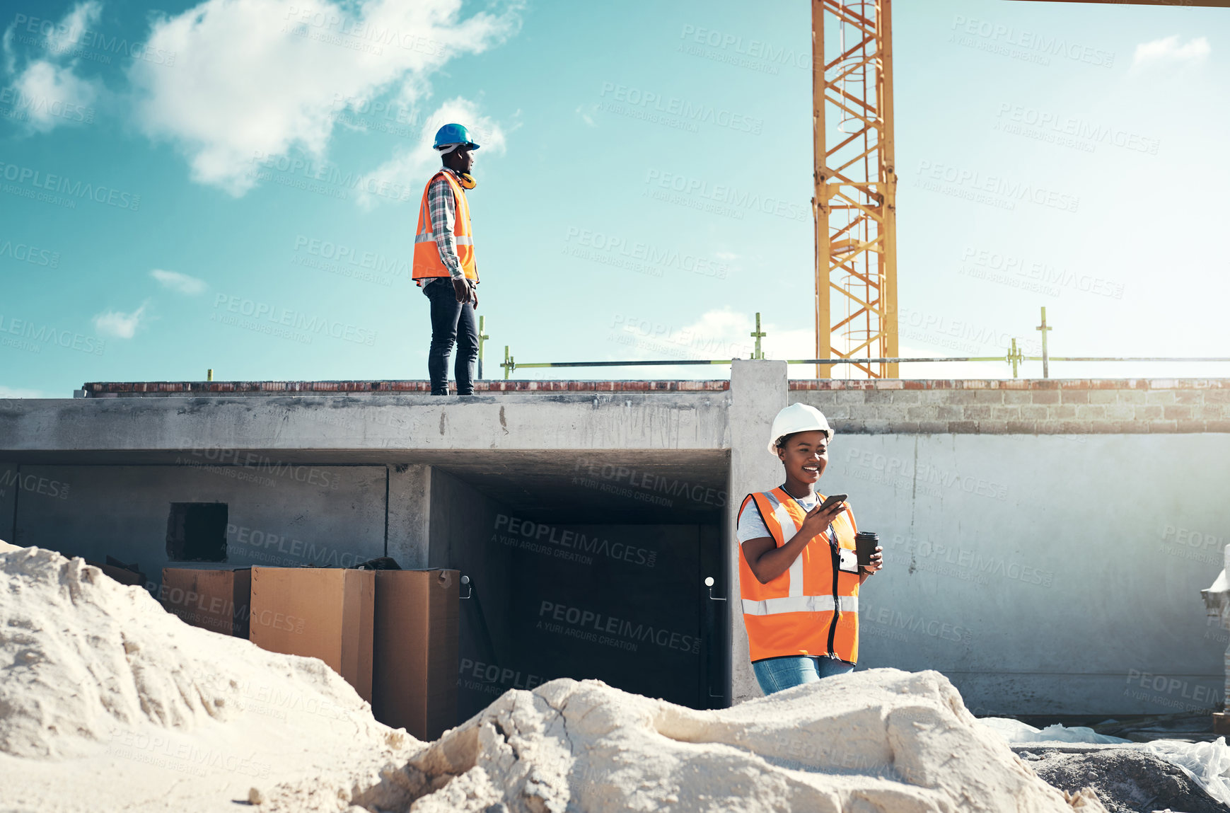 Buy stock photo Shot of a young woman using a smartphone on a coffee break at a construction site