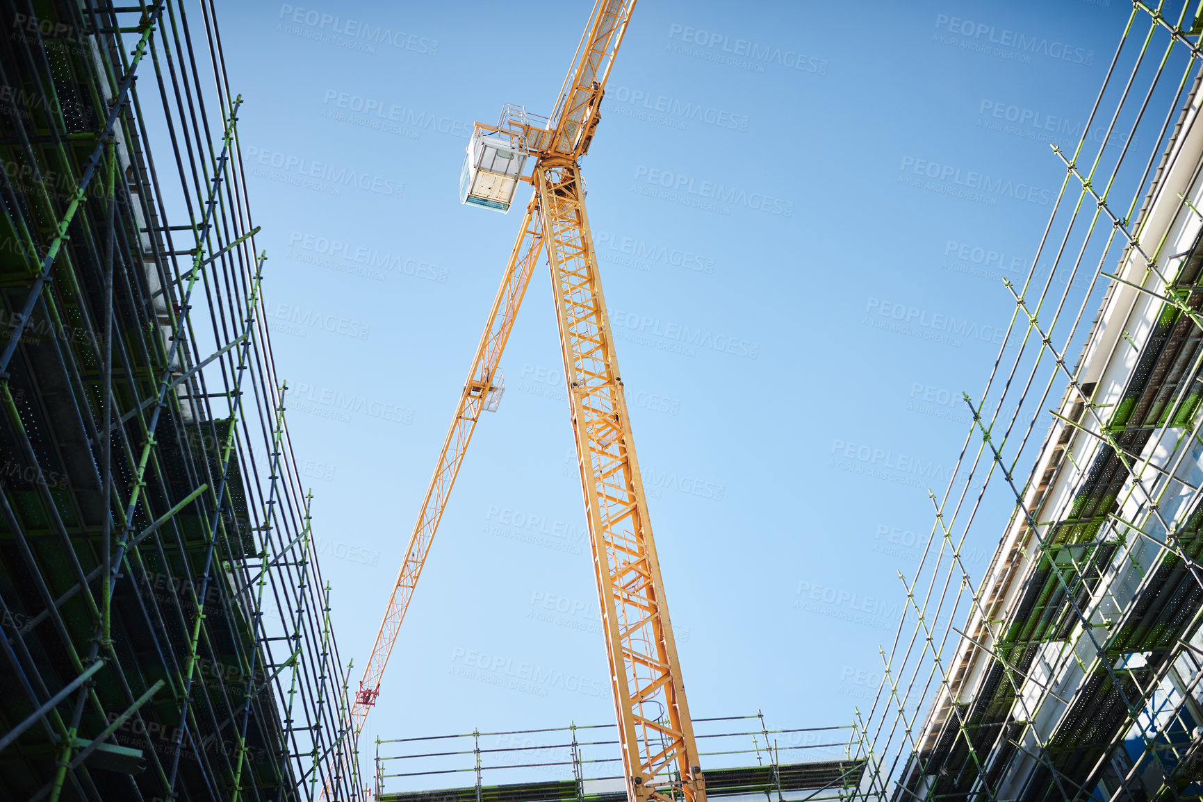 Buy stock photo Building, development and equipment in construction site with crane, machinery and structure of metal. Sky, architecture and engineering for business project with tools, steel or lift heavy materials