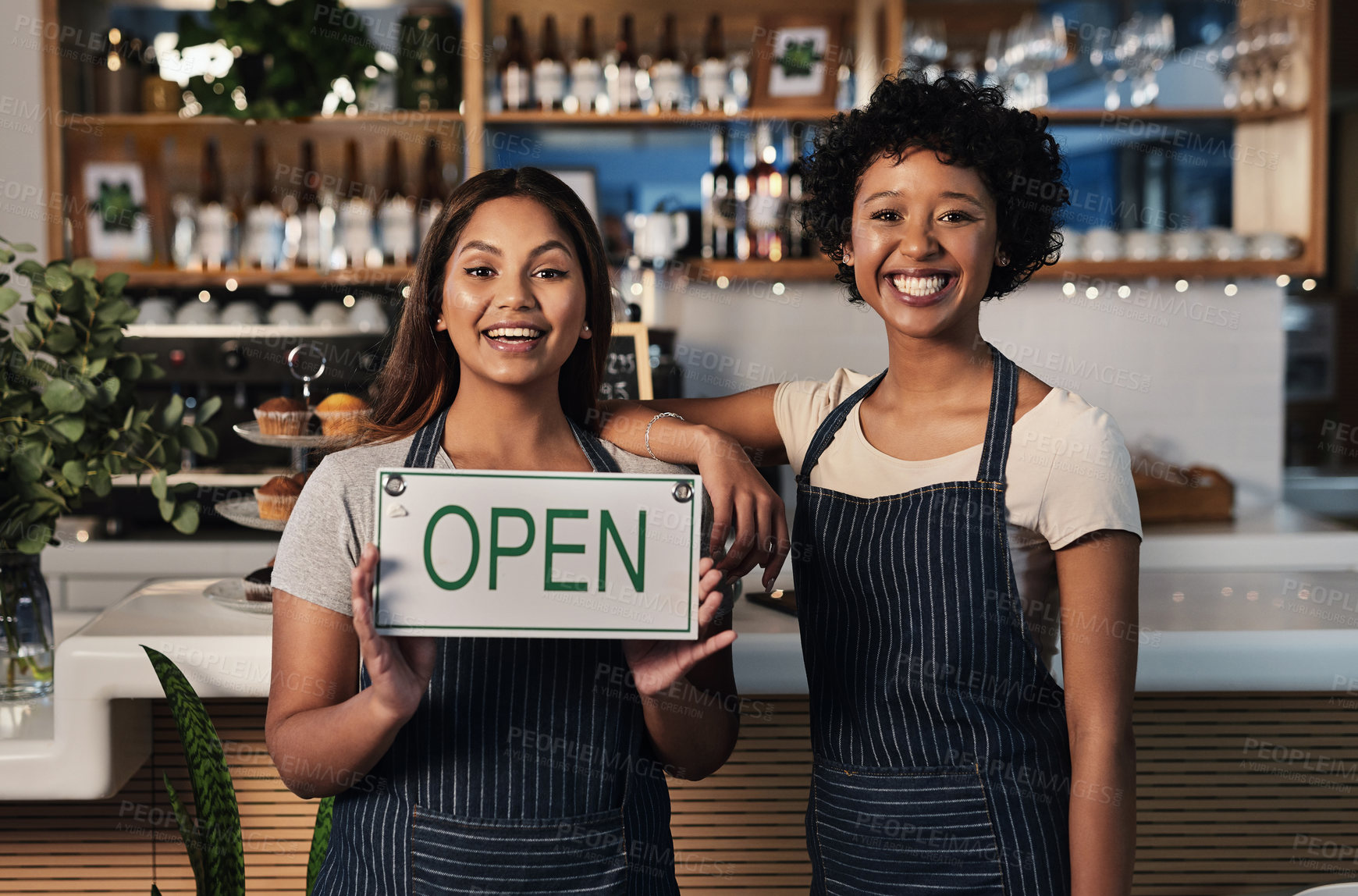 Buy stock photo Portrait of two young women holding an 