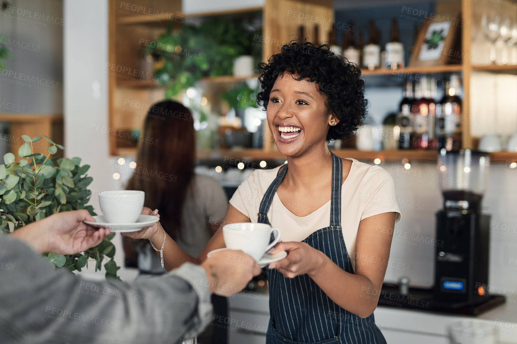 Buy stock photo Shot of a young woman serving coffee to a customer in a cafe