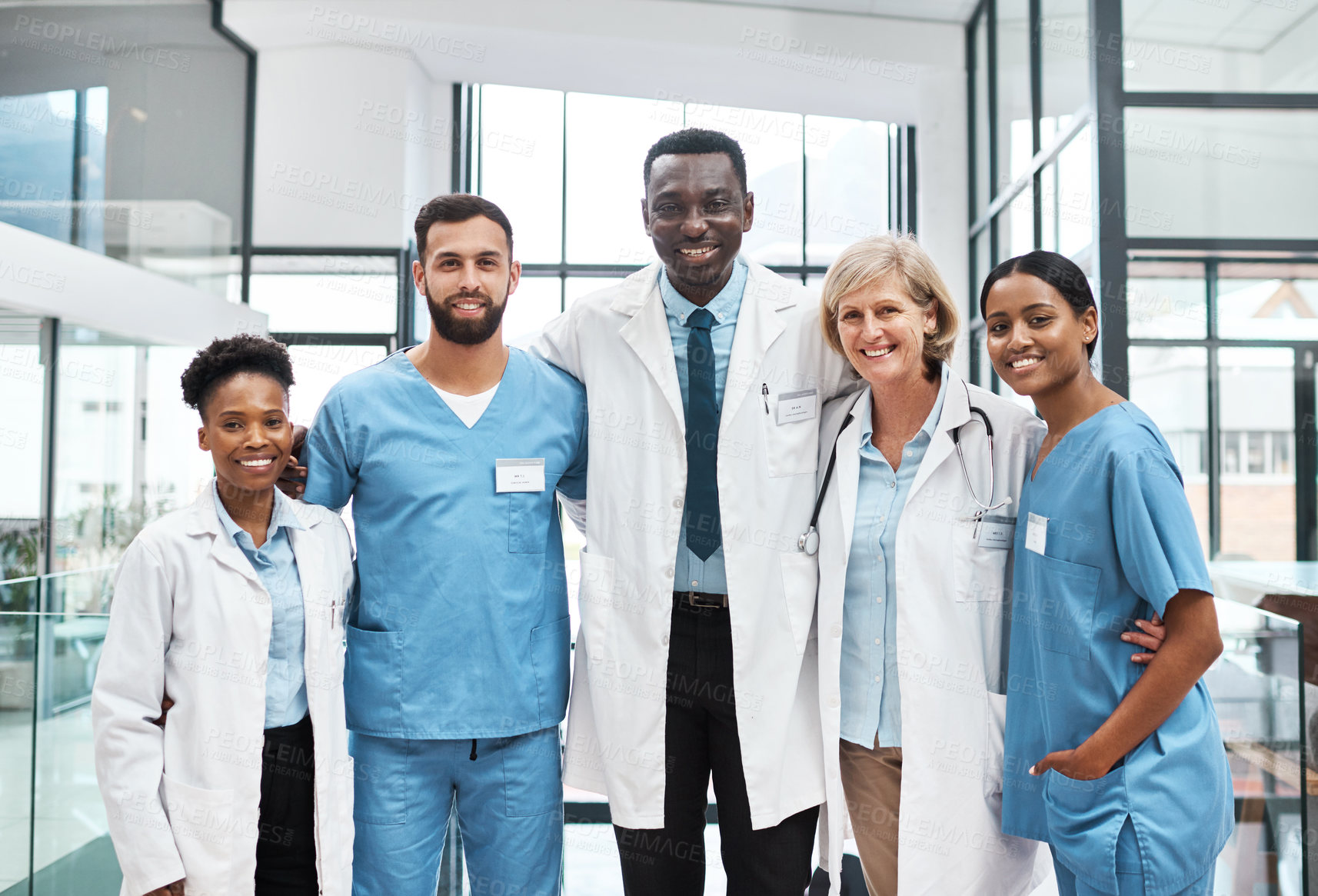 Buy stock photo Happy, doctors and nurses in portrait with embrace, solidarity and support in healthcare in clinic. Hospital, diversity and medical team in row with pride, trust and group of people with confidence