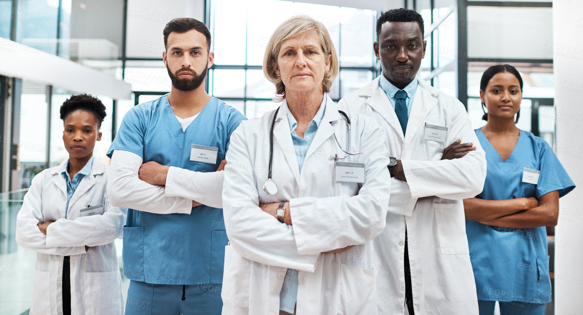 Buy stock photo Doctors, confidence and woman in portrait with arms crossed, leadership and support in healthcare. Hospital, diversity and serious medical team with nurses, pride or group of people in solidarity