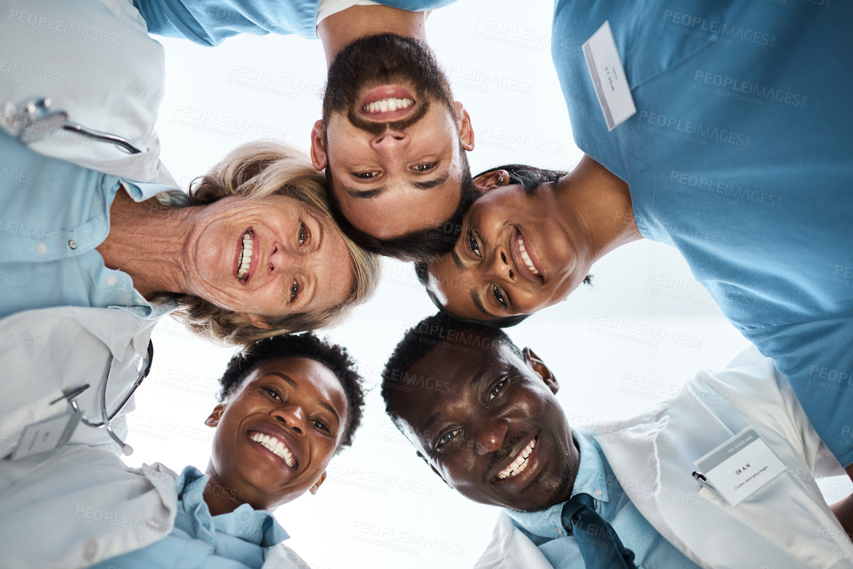 Buy stock photo Portrait, circle and medical people at hospital with teamwork, healthcare services and wellness support. Below, staff and huddle with collaboration goals, health values and treatment trust of synergy
