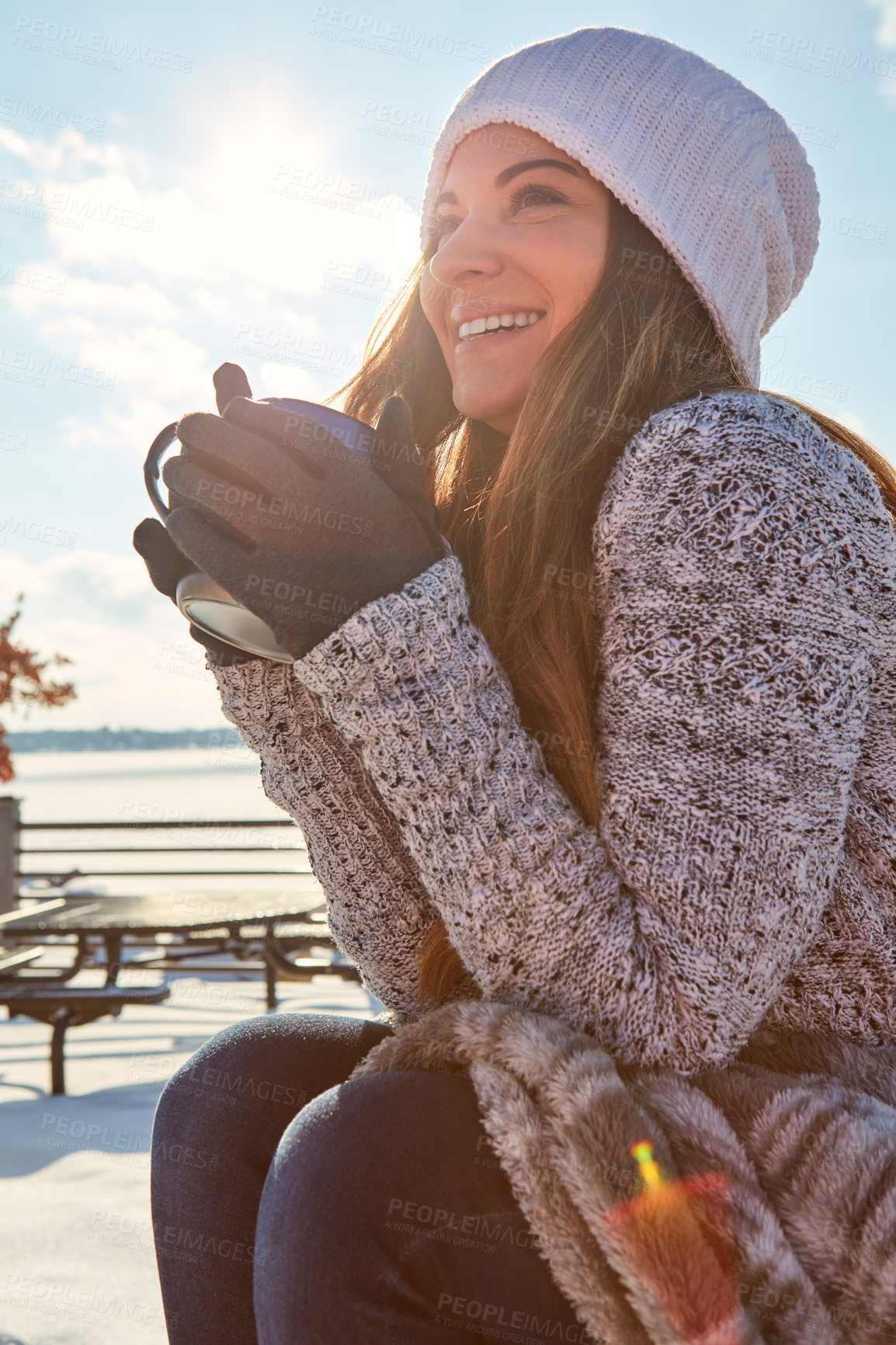 Buy stock photo Shot of a beautiful woman enjoying a hot beverage while sitting outside in the snow